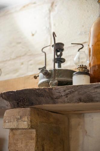 an old tea pot sitting on top of a wooden shelf at Traditional Maltese Townhouse - Close to Sea in Senglea