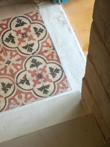 a room with a floor with a rug on the floor at Traditional Maltese Townhouse - Close to Sea in Senglea
