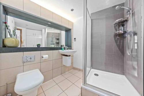a bathroom with a toilet and a sink and a shower at 1 BR in St James Piccadilly HY10 in London