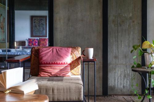 a living room with a couch and a table at StayVista at Toya Toya River View in Kozhikode