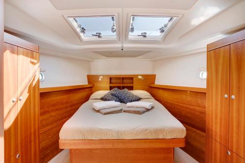 a bedroom with a bed with two pillows on it at Sailboat Hanse 455 in Positano