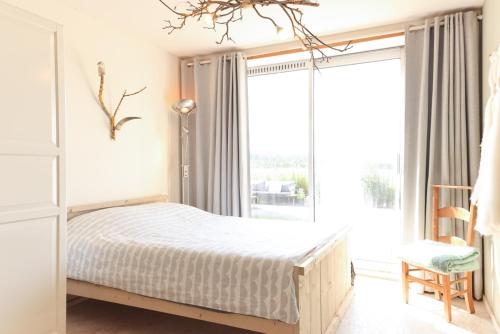 a bedroom with a bed and a large window at Bed met Paard in Bergen op Zoom