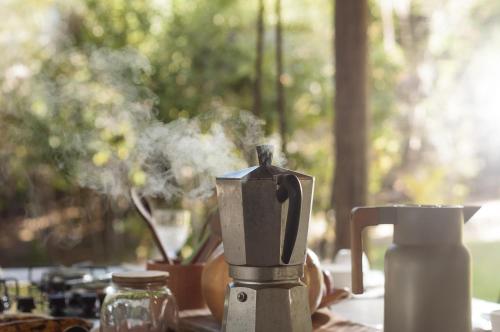 a table with a coffee maker on a table at Na Floresta Glamping in Pôrto de Pedras