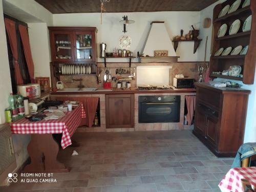 a kitchen with a table with a red and white table cloth at casale fucino monolocale in Avezzano
