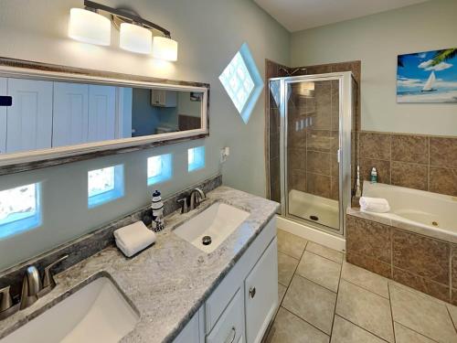 a bathroom with two sinks and a shower at Sandy Starfish in Port Aransas