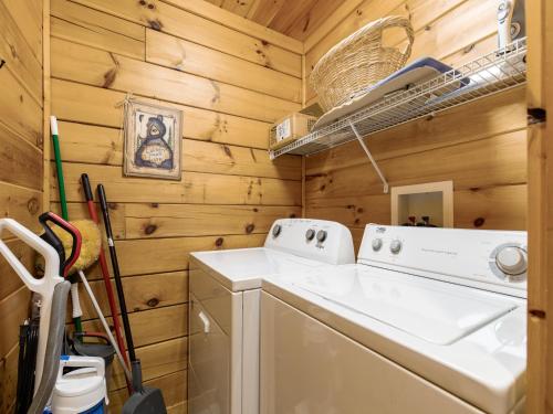 a laundry room with a washer and dryer at Bear Necessities, 1 Bedroom, Sleeps 8, Pool Table, Arcade, WiFi, Pets in Gatlinburg