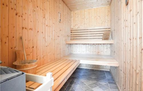 a sauna with a bench in a wooden wall at Amazing Home In Haderslev With 3 Bedrooms, Sauna And Wifi in Kelstrup Strand