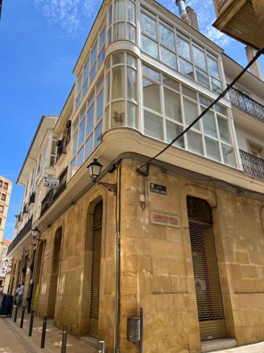 a tall building with windows on a street at Comodidad en el Centro de Haro in Haro