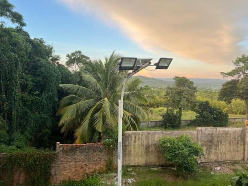 a street light with a rainbow in the background at Bungalow Sáng Tươi Mountains in Phu Quoc