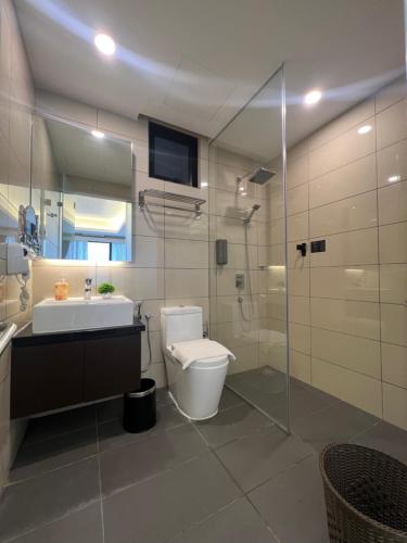 a bathroom with a toilet and a sink and a shower at QUINCE HOME GRAND ION DELEMEN GENTING HIGHLANDs in Genting Highlands