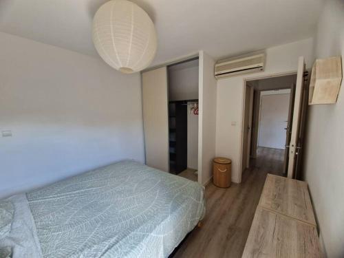 Ένα ή περισσότερα κρεβάτια σε δωμάτιο στο Appartement T2 avec jardin à Saint Gilles Les Bains