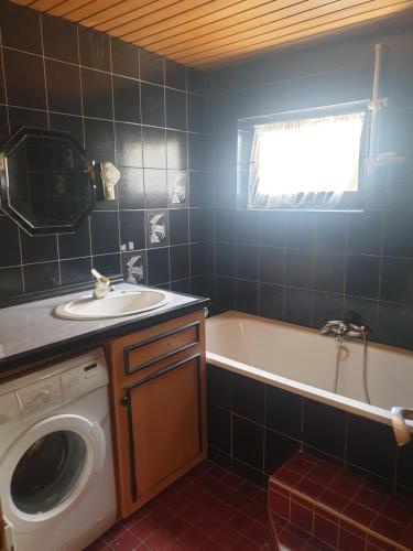 a bathroom with a sink and a washing machine at st Veit 