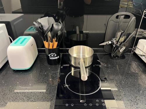 a kitchen counter with a pot on a stove at QUINCE HOME GRAND ION DELEMEN GENTING HIGHLANDs in Genting Highlands