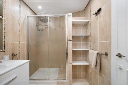 a shower with a glass door in a bathroom at Puerto Marina Luxury Studio in Benalmádena