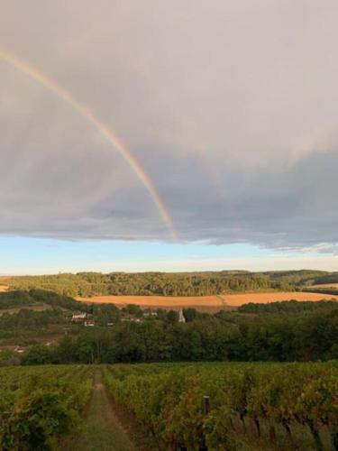 a rainbow in the sky over a field at Nouveau - Maison confortable à Gevrey-Chambertin in Gevrey-Chambertin