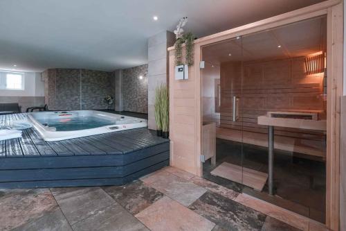 a large bathroom with a jacuzzi tub in it at Les Bastides de Roquemaure 