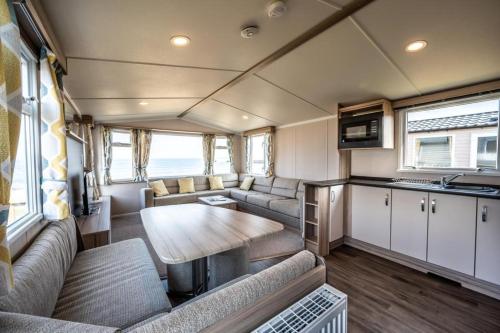a kitchen and living room of an rv at Gold Holiday Caravan: 3 bedroom Sleeps 6 (68) in Hopeman