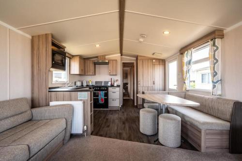 a kitchen and living room in a caravan at Gold Holiday Caravan: 3 bedroom Sleeps 6 (68) in Hopeman