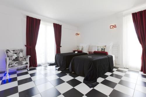 a bedroom with two beds and a checkered floor at Cella Hotel & SPA Ephesus in Selcuk