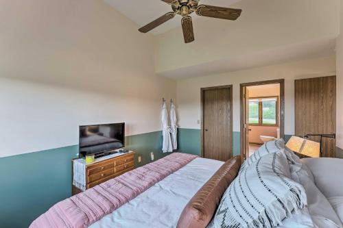a bedroom with a bed and a flat screen tv at The Golf View, boutique Galena getaway! in Galena