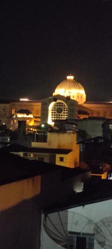a building with a lit up dome at night at Casa Temporada em Aparecida com vista para Basílica in Aparecida