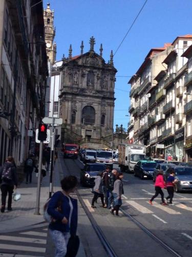 a group of people crossing a city street with an old building at Porto Chique AL 2 in Porto