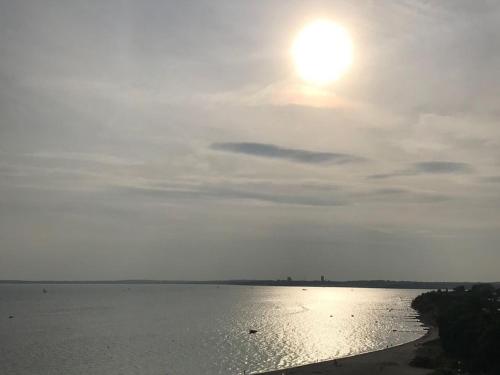 a large body of water with the sun in the sky at Herrmann Jens in Pelzerhaken