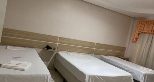 a hospital room with two beds and a window at IMPERADOR Hotel in Lajeado Grande