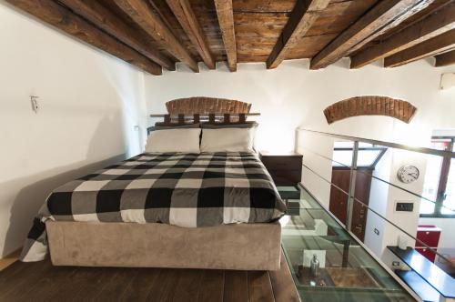 a bedroom with a bed and a glass floor at Lombardini Loft Navigli in Milan