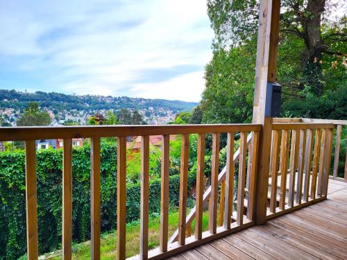 a wooden deck with a view of a city at Le Bellevue - Beaux appartements avec vue splendide in Palaiseau