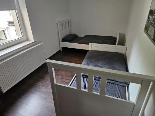 a small room with two bunk beds and a window at FeWo2 Köthen 