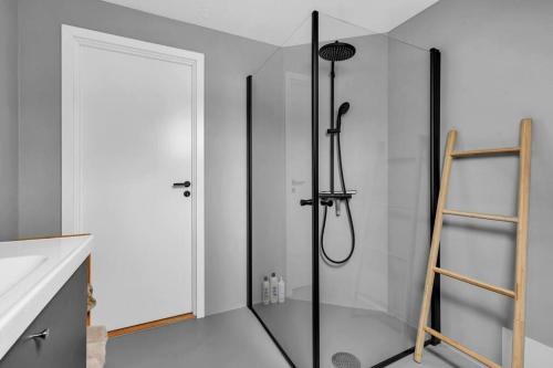 a bathroom with a shower with a glass door at Luxurious Penthouse in the Middle of City Center in Bergen