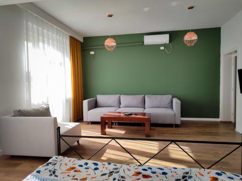 a living room with a couch and a table at Urban Cozy Retreat in Pristina