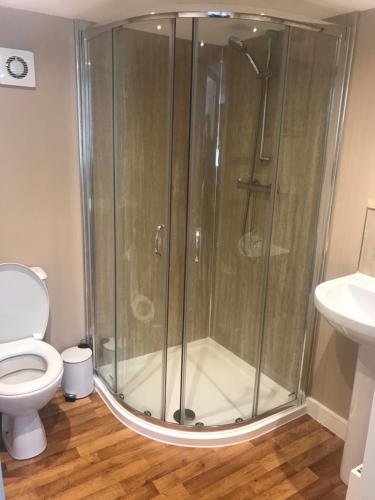 a shower stall in a bathroom with a toilet at 2 Bedroom Self-Catering Chalet in Steps