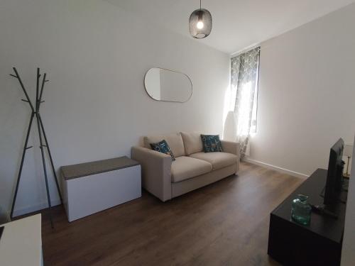 a living room with a couch and a table at Résidence Beaudelot in Saint-Saulve
