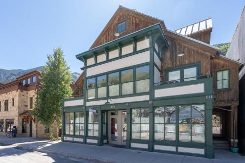 a building with green and white trim on a street at East Side Hideaway in Telluride