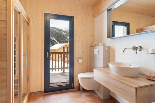 a bathroom with a toilet and a sink and a window at Chalet in Hohentauern - Chalet Ana in Hohentauern