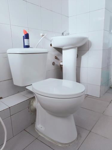 a bathroom with a white toilet and a sink at Studio Apartment.Mombasa, Kenya in Mombasa