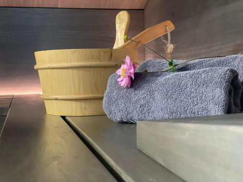 a flower sitting on a table next to a basket at BergChalet in Garmisch-Partenkirchen
