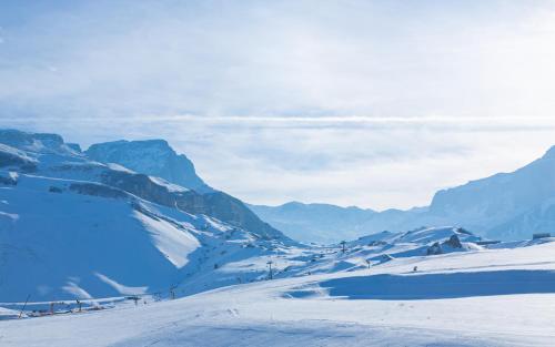a snow covered mountain with mountains in the background at Park Chalet, Shahdag, Autograph Collection in Shahdag
