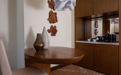 a kitchen with a wooden table and a counter at Park Chalet, Shahdag, Autograph Collection in Shahdag