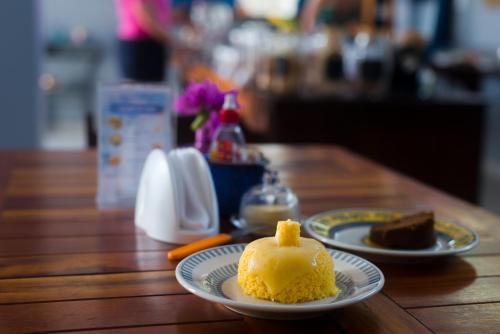 a piece of cake sitting on a wooden table at Pousada Vila de Charme in Barreirinhas