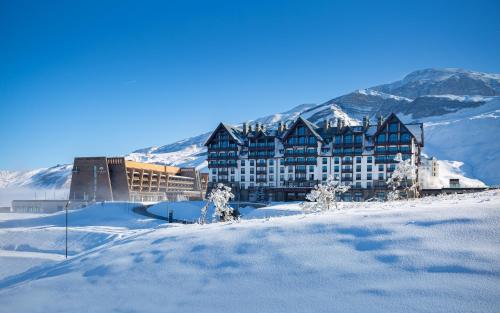 a large building in the snow on a mountain at Park Chalet, Shahdag, Autograph Collection in Shahdag