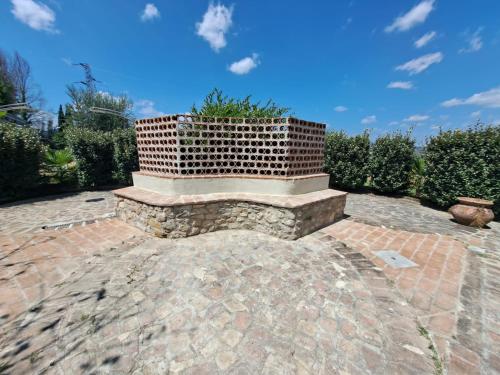 a brick bench with a planter on a brick patio at Spoleto by the pool in Spoleto