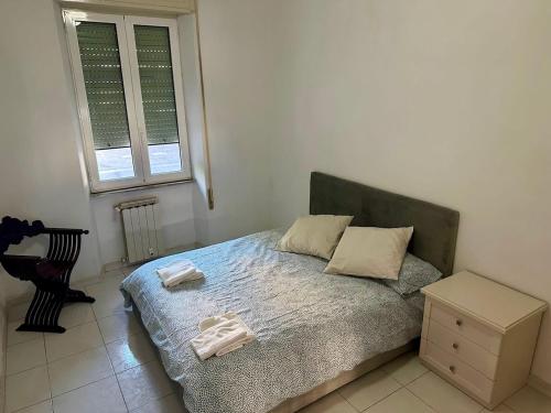 a bedroom with a bed with two towels on it at holiday home in the Vatican in Rome