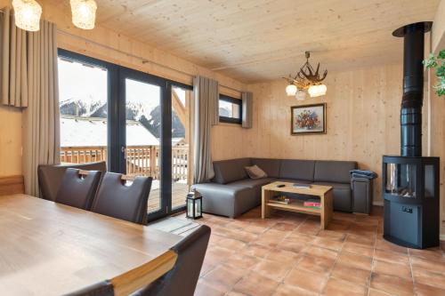 a living room with a couch and a table at Chalet in Hohentauern - Chalet Ana in Hohentauern