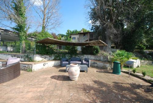 a patio with a large white vase in a yard at Spoleto by the pool in Spoleto