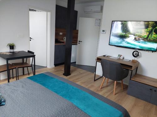 a room with a bed and a flat screen tv at COMFORT Suites VELIKA GORICA in Velika Gorica