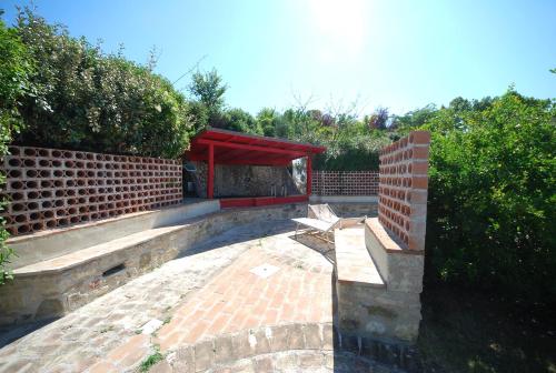a patio with a bench and a brick wall at Spoleto by the pool in Spoleto