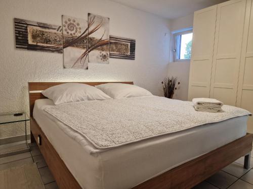 a bedroom with a large white bed in a room at Bei s' Herrs in Rheinmunster